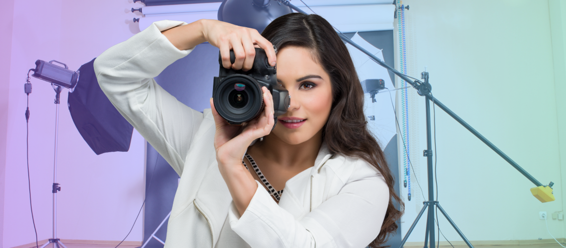woman shooting with a dslr camera in a photo studio for brand photography